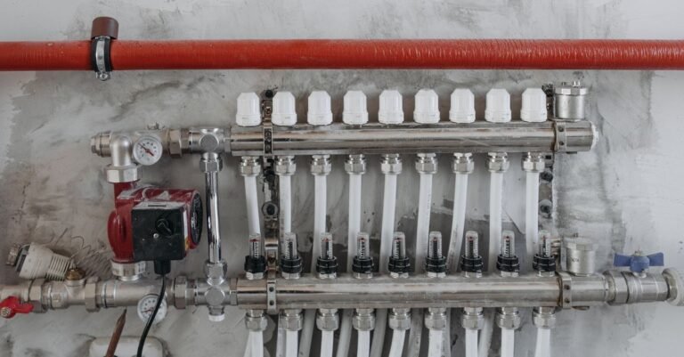A close-up industrial manifold with pressure gauges and steel pipes, the kind of assembly a relief valve protects