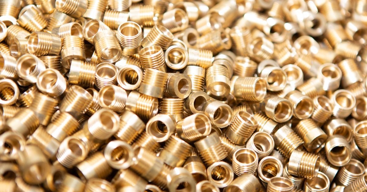 Close-up of brass nuts and threaded fittings, the kind of inlet thread that admits air without ever leaking a drop of water