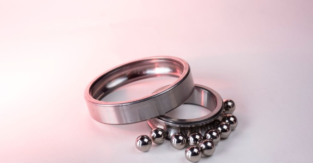 Polished steel ball bearings and races photographed on a white background