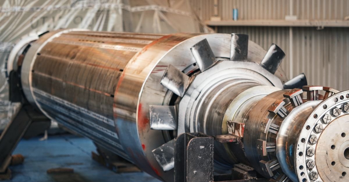 Heavy industrial rotor machinery in a workshop, the part of a motor that takes the heat during every start