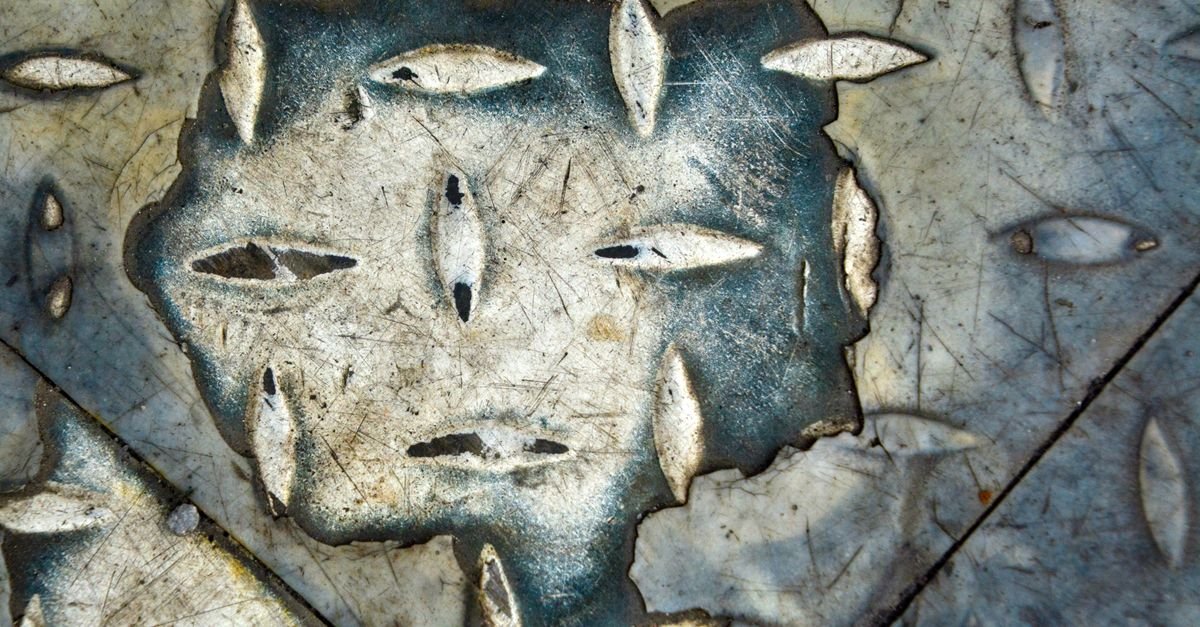 Weathered metal showing worn, eroded surface patterns