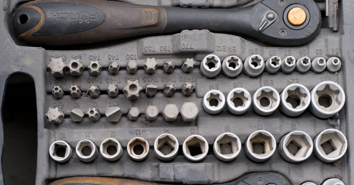 A socket ratchet set laid out with a selection of sockets and extensions, the only tool needed to check every mounting bolt on a pressure washer