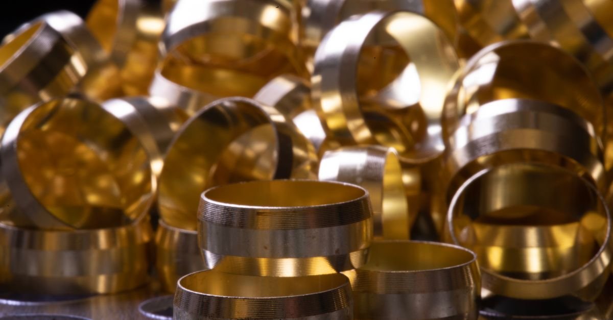 Stacked brass and copper rings with a machined metallic finish, the kind of sealing ring and ferrule that takes the full pressure cycle every time a trigger closes