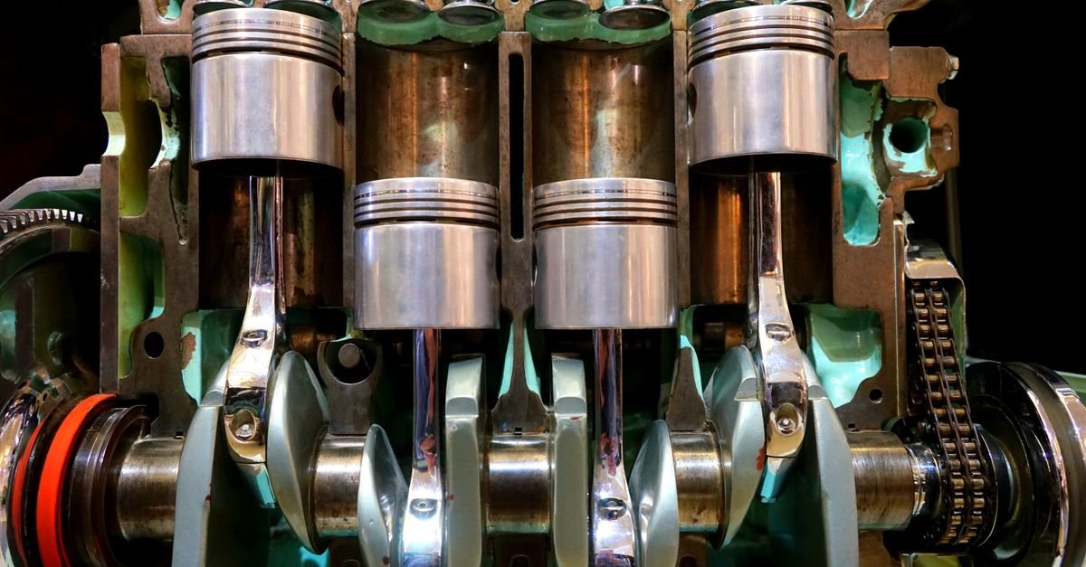 Close-up of engine pistons and a crankshaft, the layout a triplex pump crankcase shares