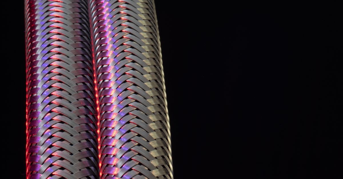 Close-up of braided metallic hose construction showing the reinforcement pattern