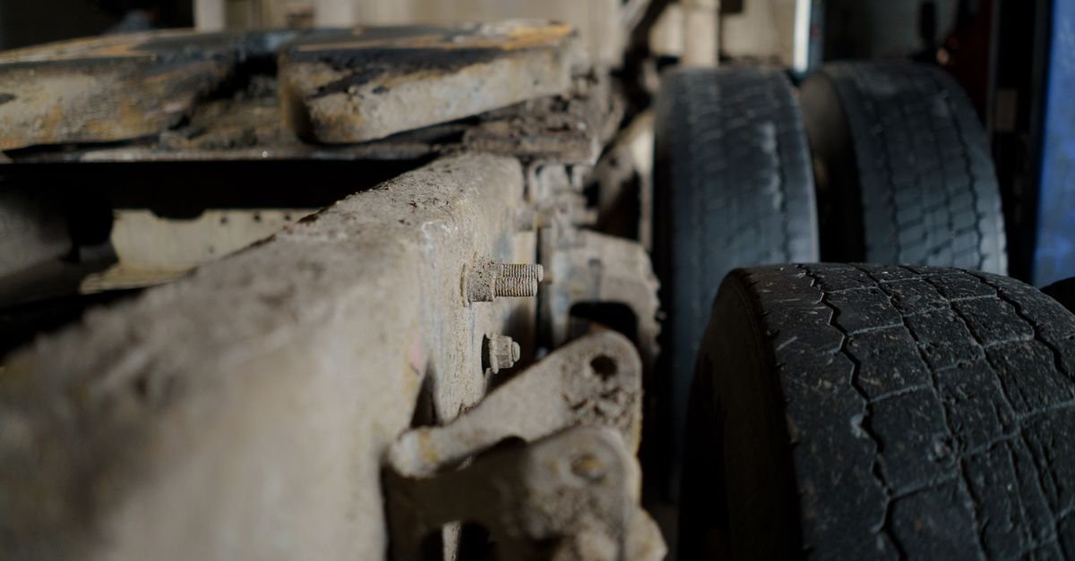 Close-up of a dirty truck chassis, suspension and tyre