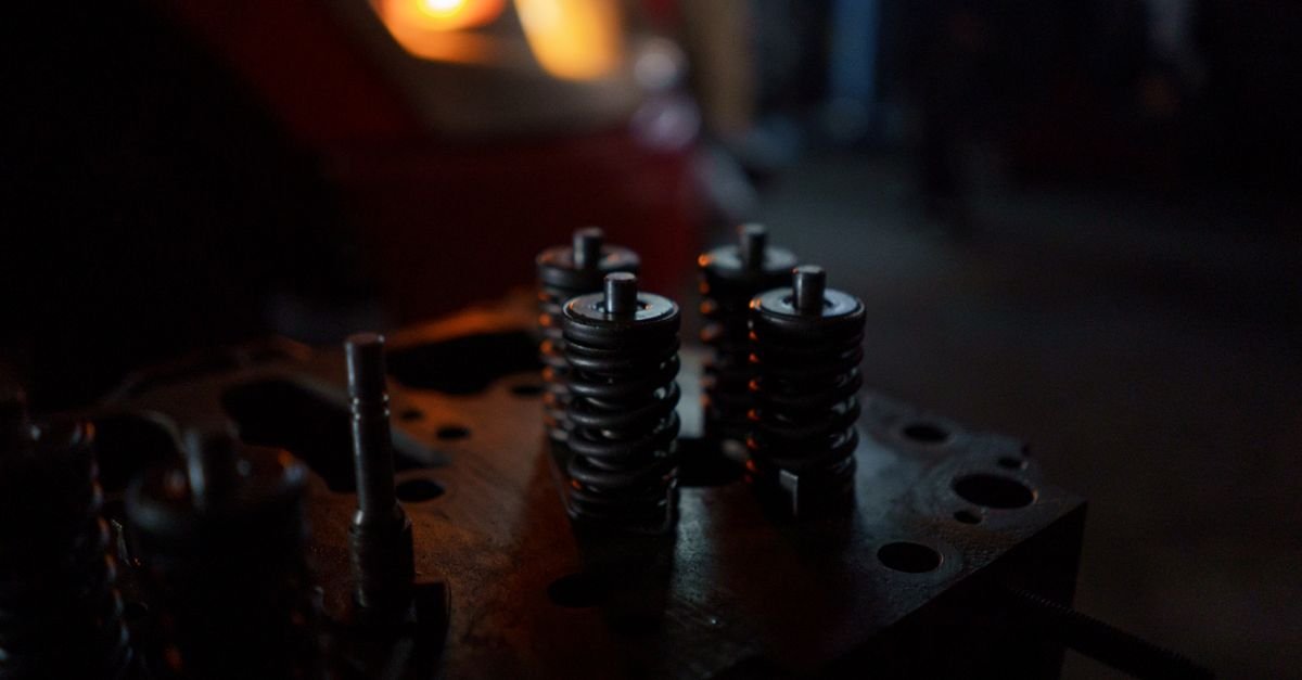 A close-up of engine valve springs and seats on a cylinder head, the same family of parts supplied in a pump valve kit