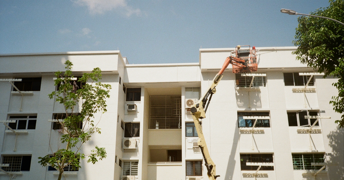Maintenance being carried out on a residential building from an elevated lift