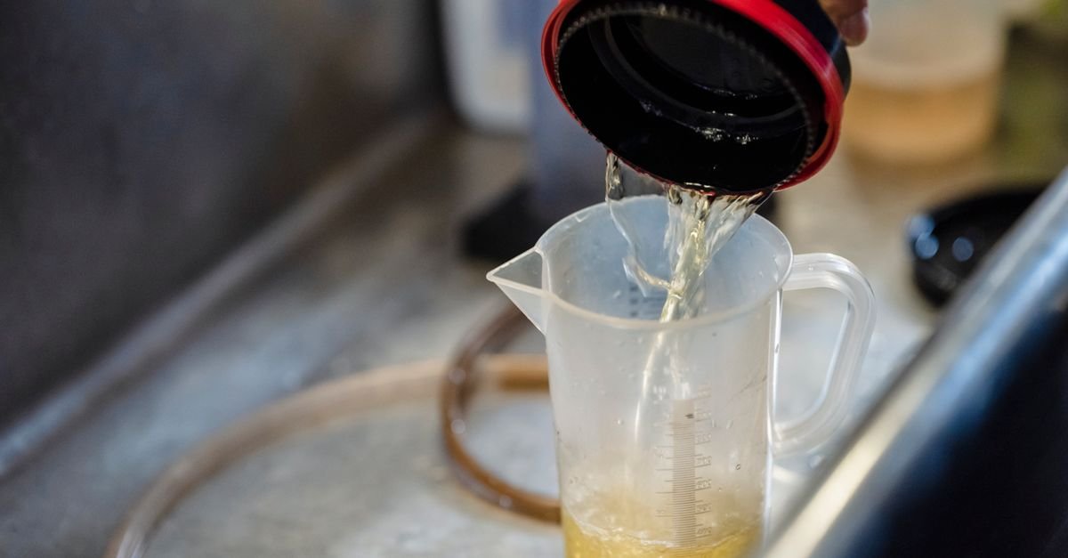 Water being poured into a clear measuring cup to check a dilution