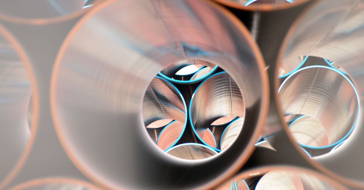 Polished steel tubes of differing diameters stacked together, their open ends showing the thin walls a sliding telescopic section relies on