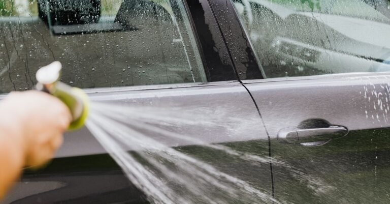 Strong fan of water rinsing a car door, showing the water volume a higher-GPM machine delivers