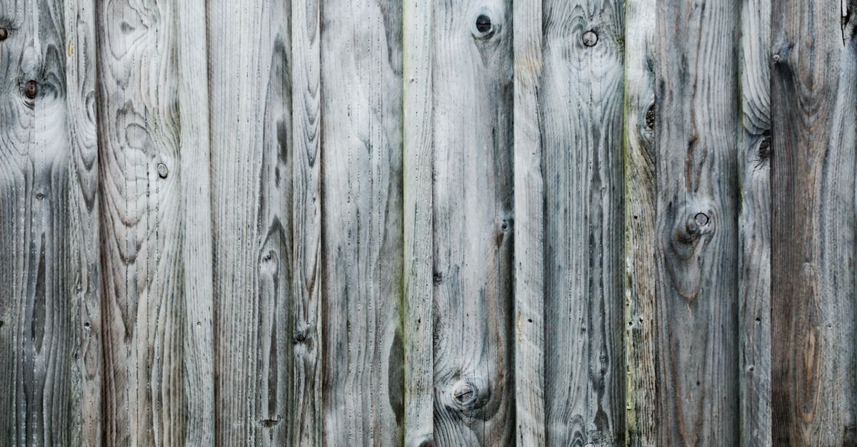 Close-up of a weathered wooden surface showing natural grain and texture