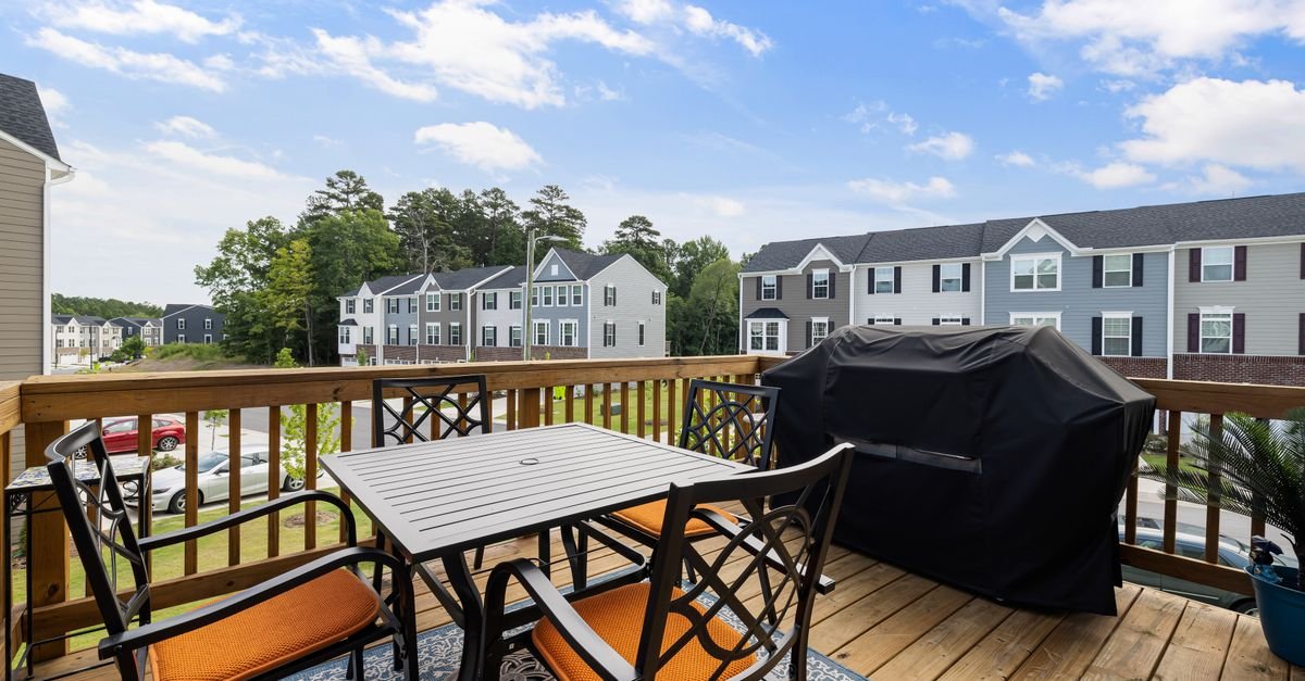 Residential deck with outdoor furniture and a grill