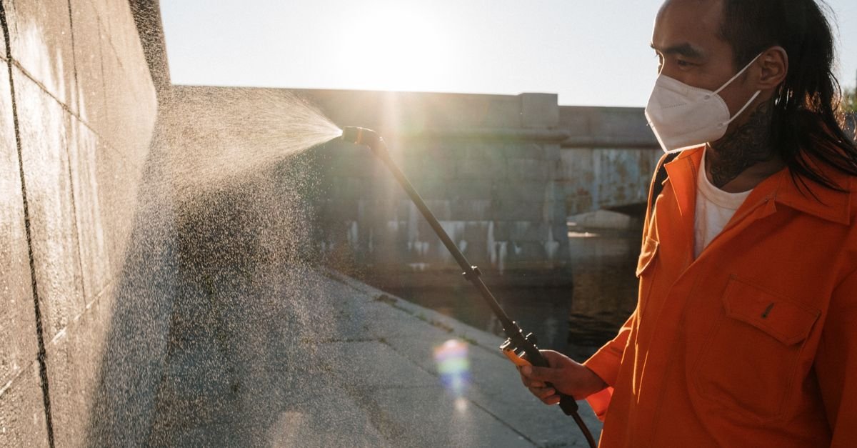 Wide fan-pattern nozzle spray from a pressure washer wand, the low-impact technique composite needs