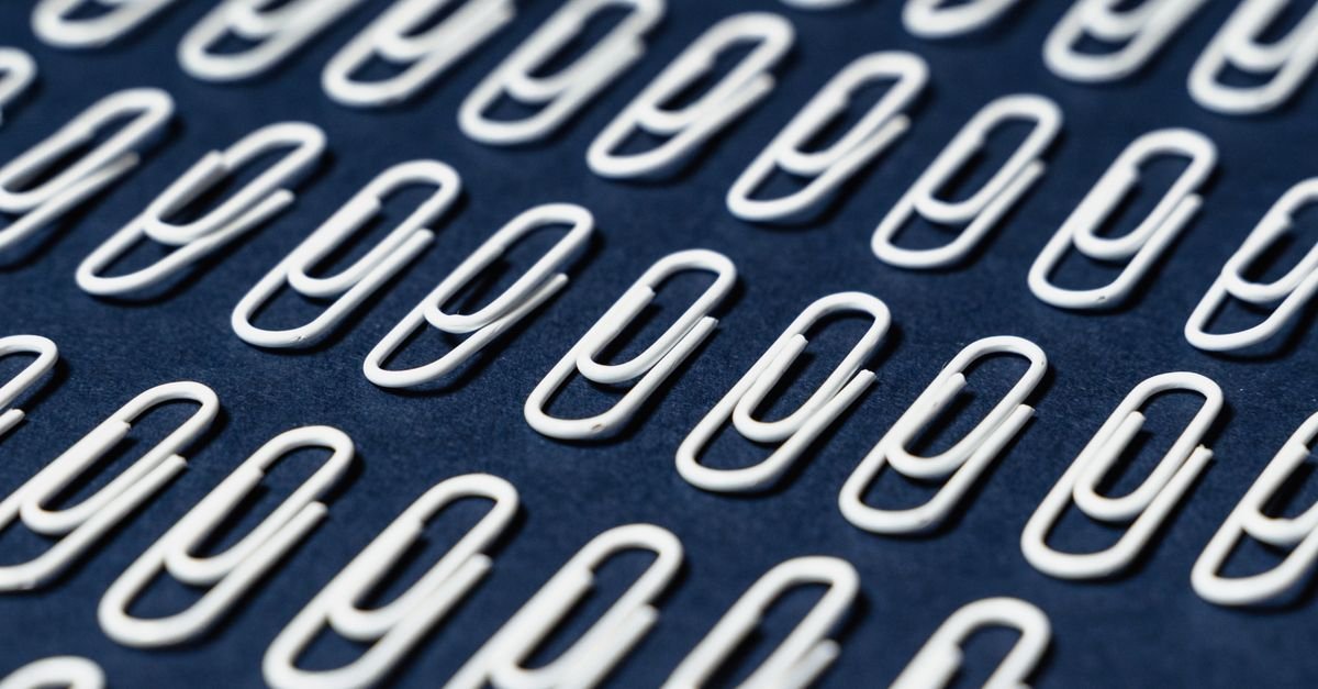 Rows of thin white paper clips — the kind of wire that should never be forced into a nozzle