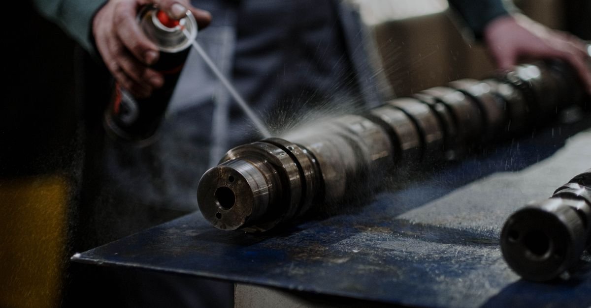 Degreaser being sprayed onto an oily metal part