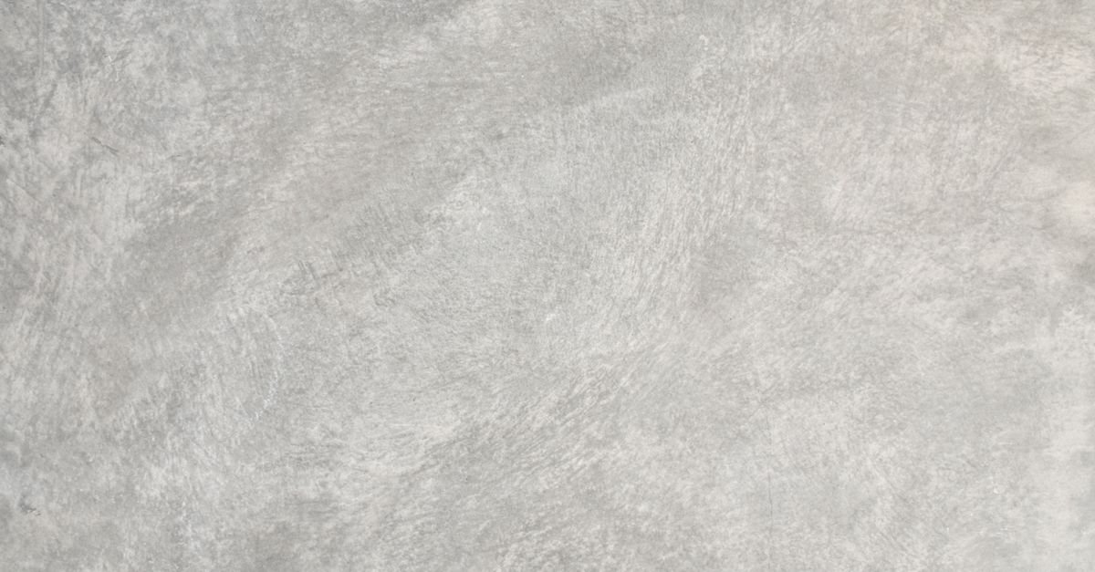 Close-up of a rough, open-textured concrete surface, the profile that drinks a sealer faster than a troweled one