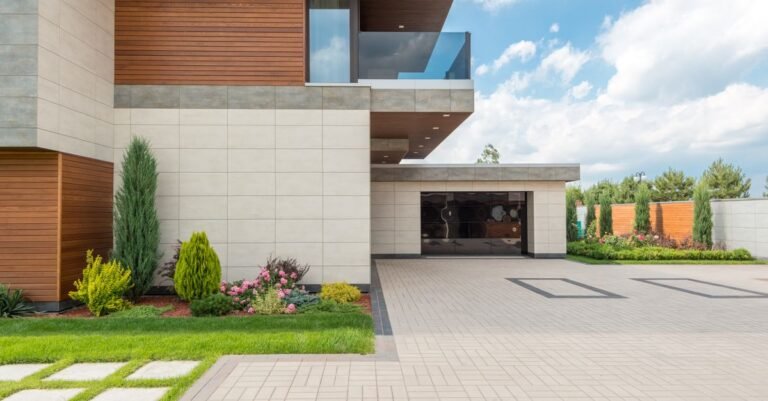Wide concrete driveway and landscaped frontage of a suburban house, the flatwork a gas pressure washer gets bought for