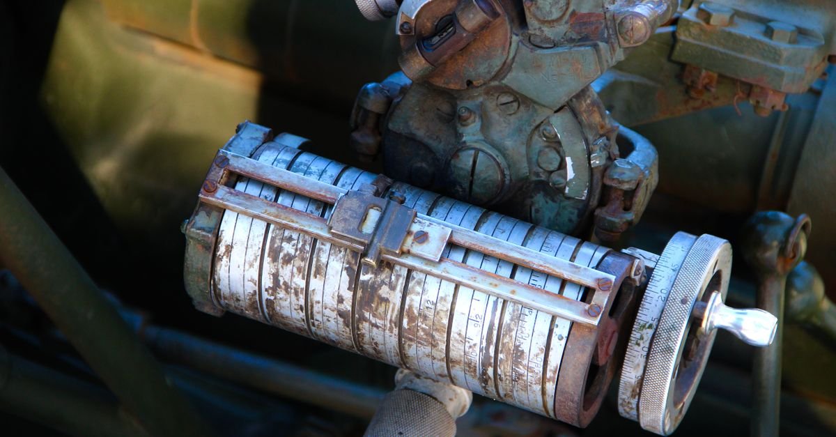 A rusty, vintage industrial machine component photographed in a workshop, the corrosion and wear that ends a pump's working life