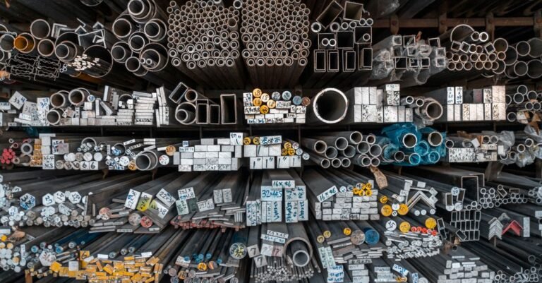 Assorted metal bars, tubes and pipes of different diameters stacked on industrial storage shelves